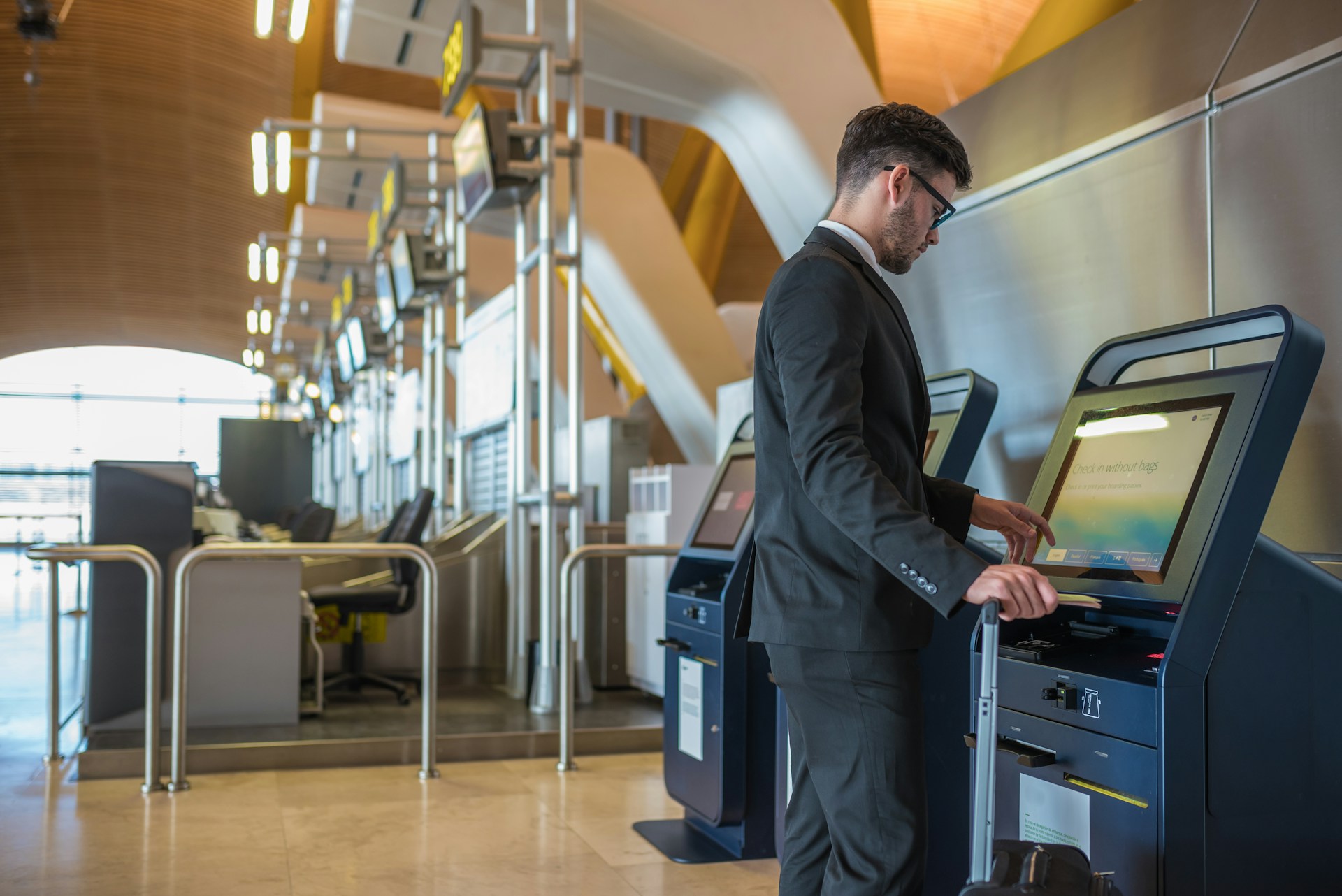 Man using self-service kiosk at airport