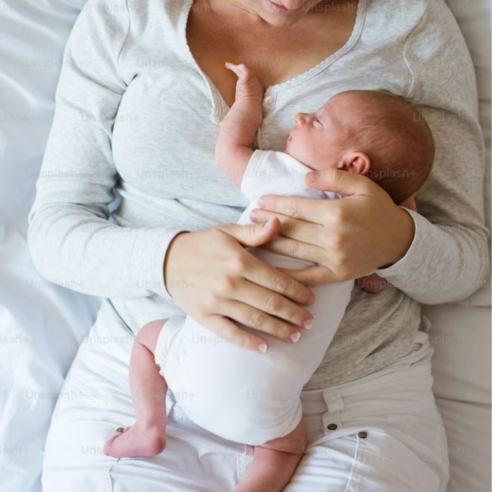 Mother holding a newborn baby on her chest