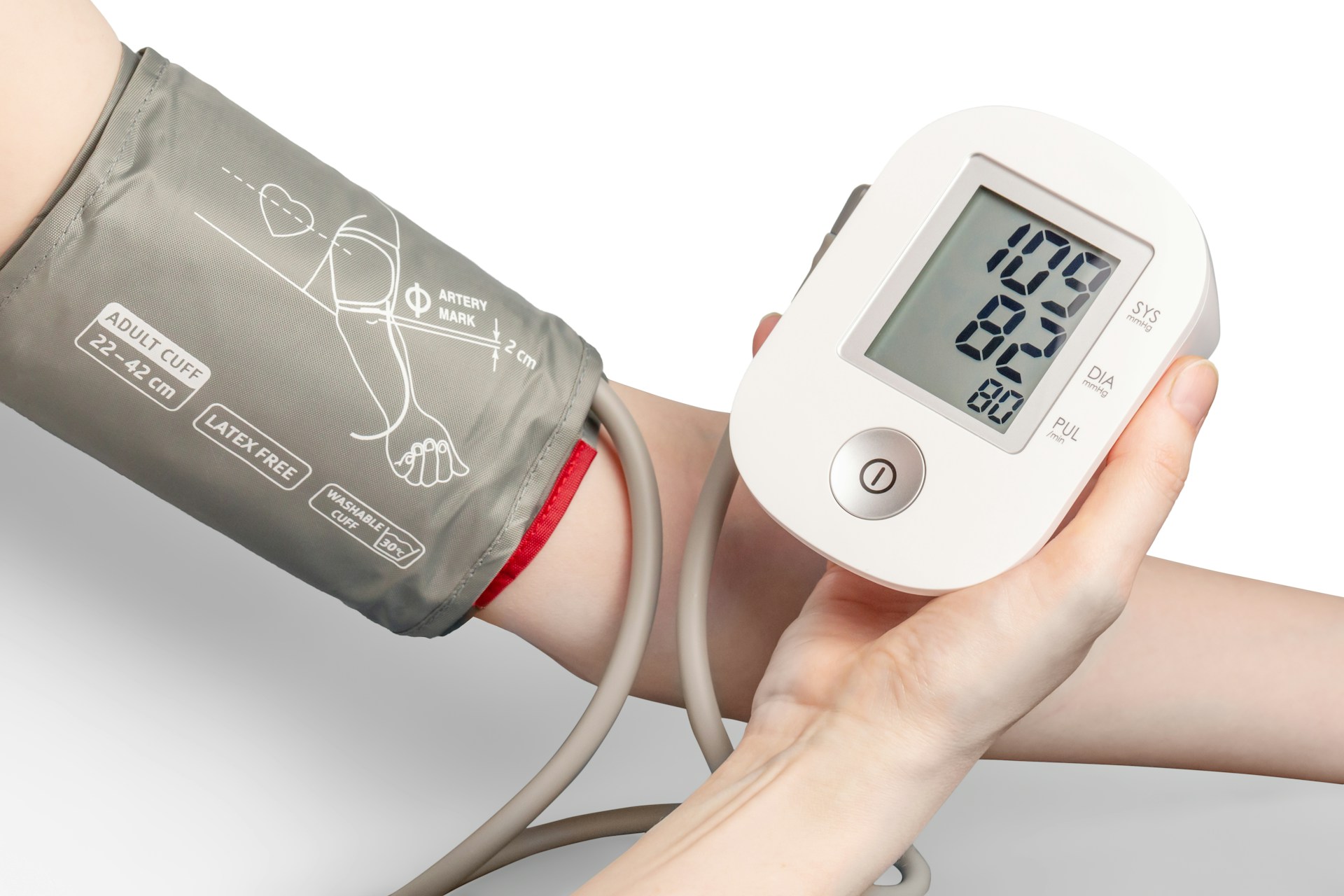 Person using a digital blood pressure monitor on an arm