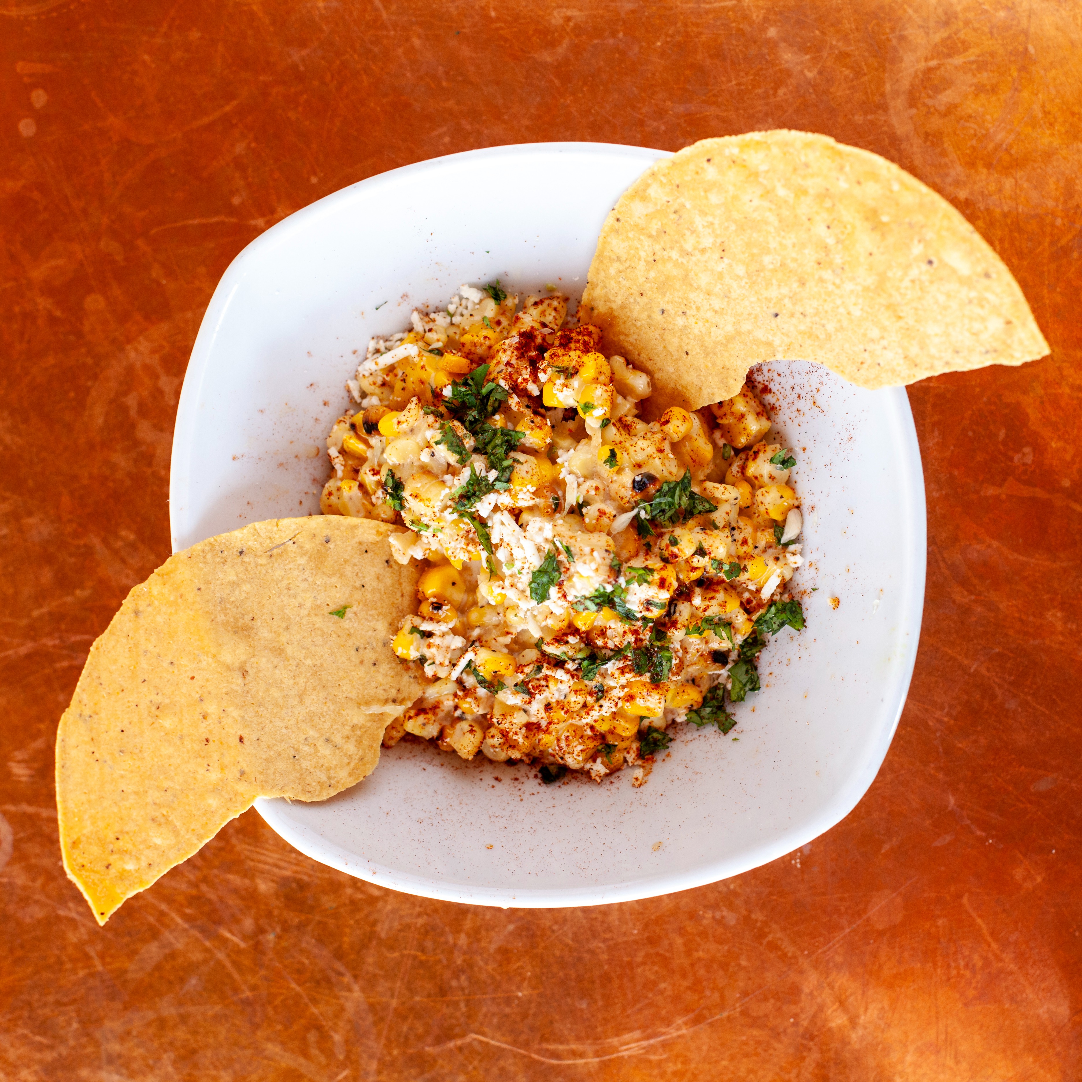Elote (Mexican street corn) salad made with Ayoh Original Mayo and garnished with tortilla halves