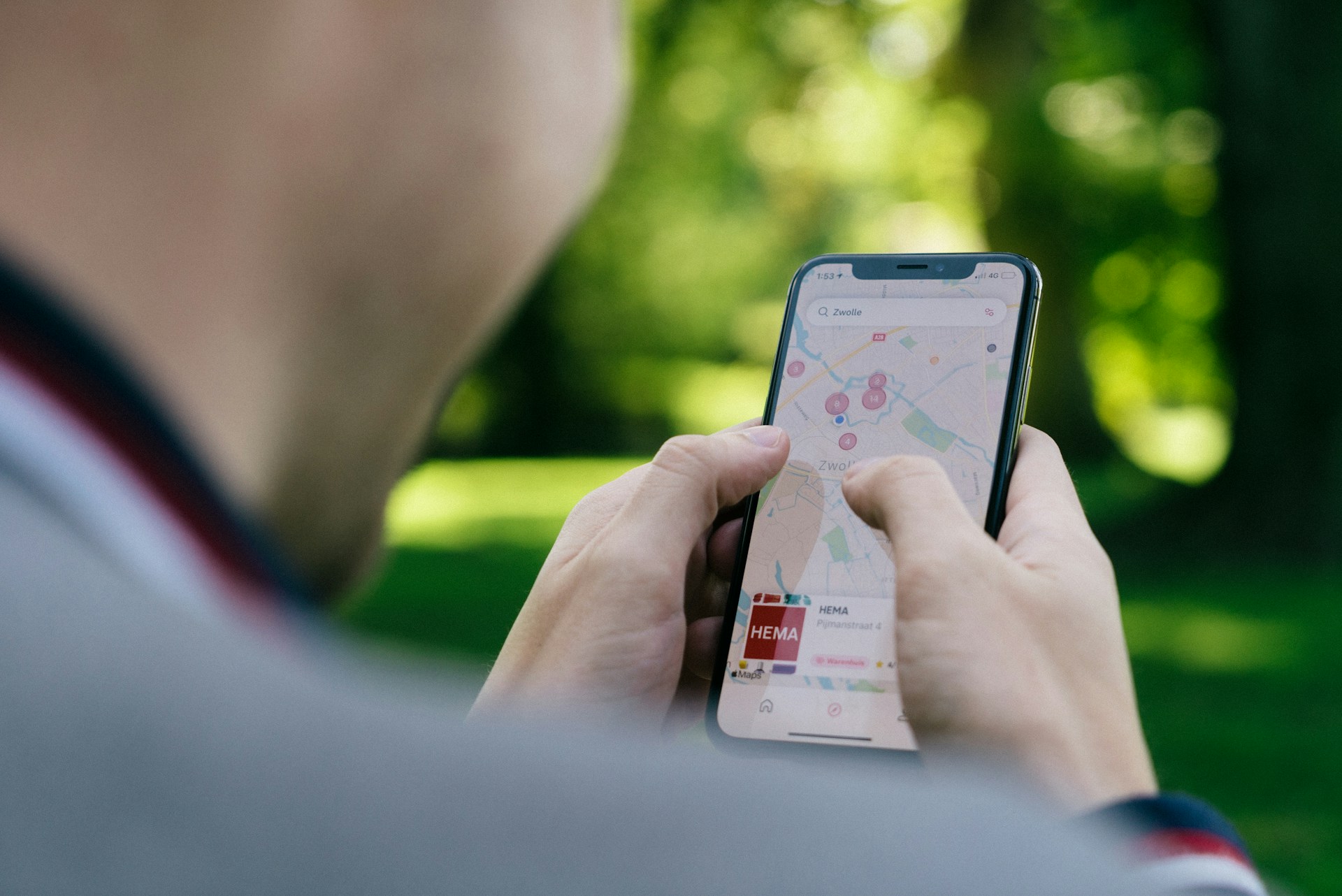 Person using a smartphone to view a map outdoors