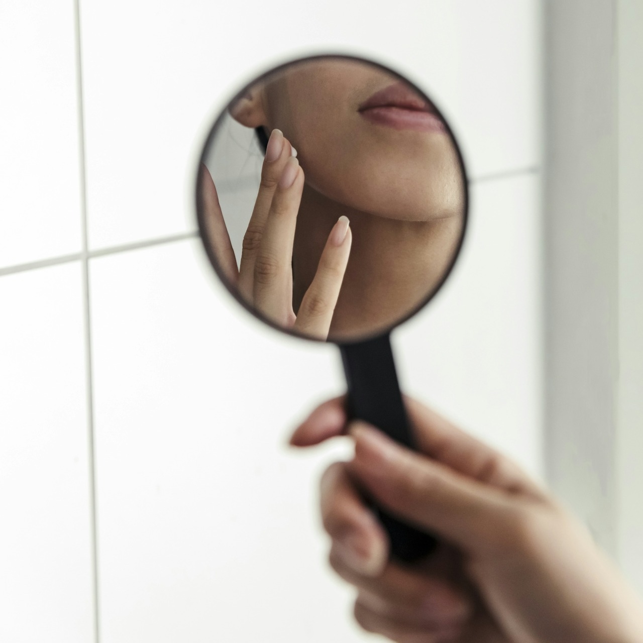 Close-Up Skin Examination with Mirror Person examining their skin with a handheld mirror