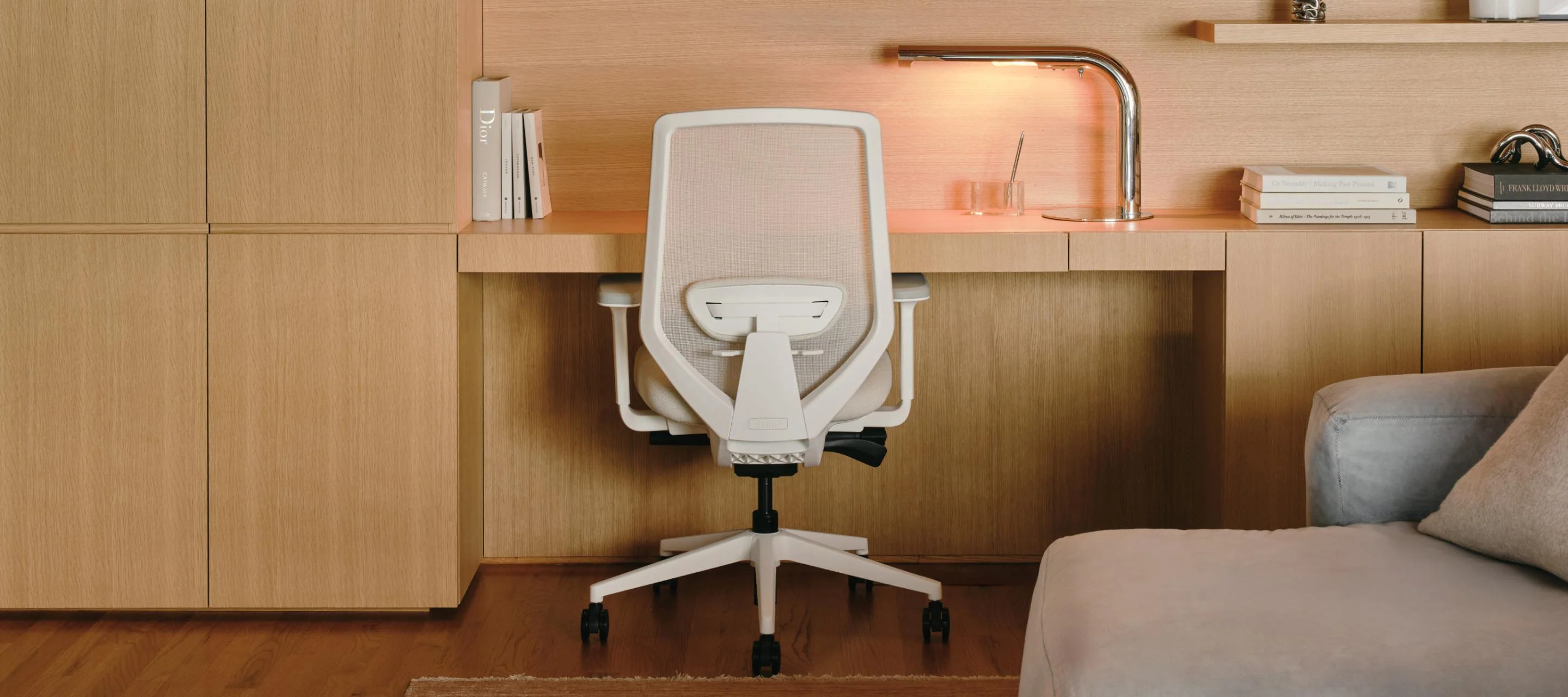 Modern home office setup with ergonomic chair and wooden desk
