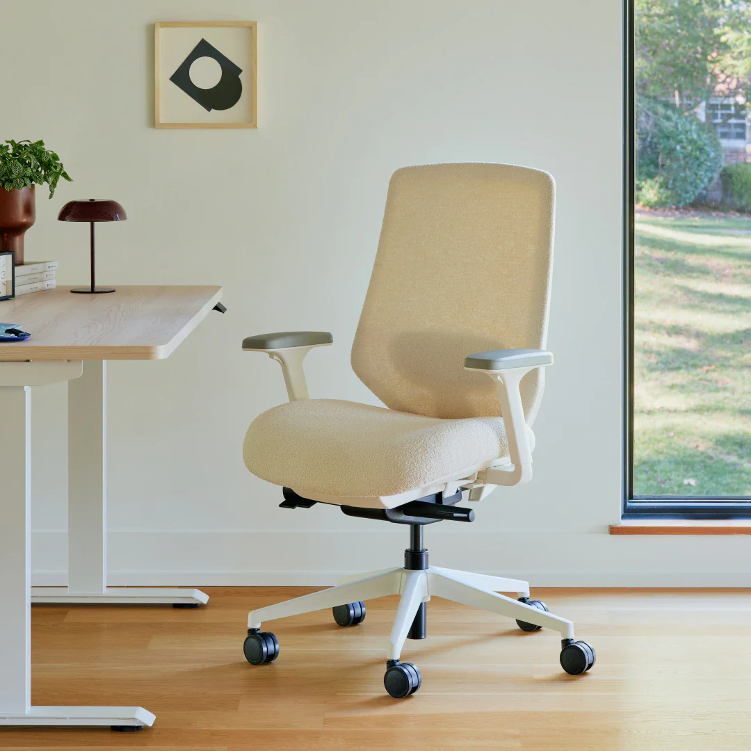 Modern ergonomic office chair beside a wooden desk