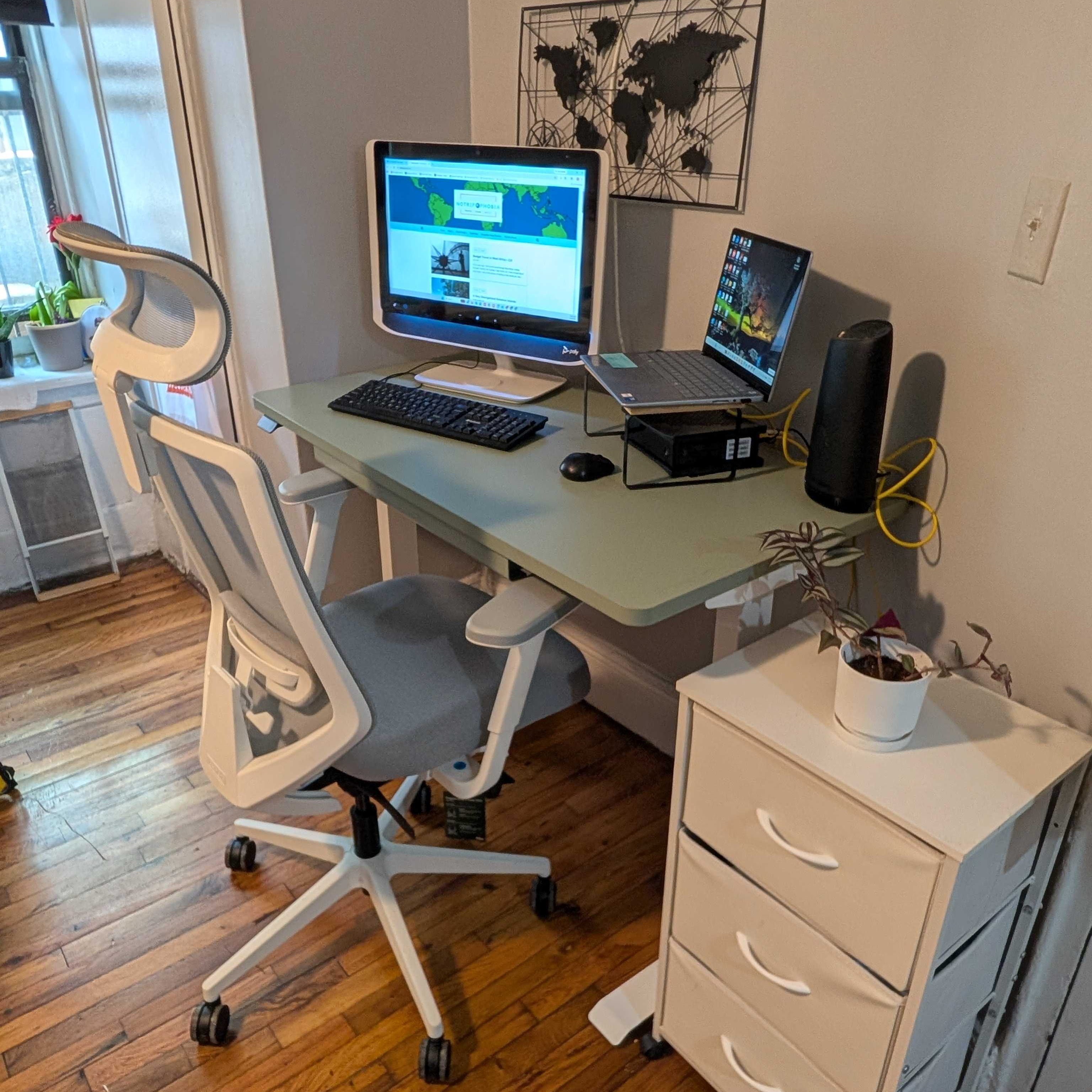 Home office setup with desk, chair, monitor, and laptop