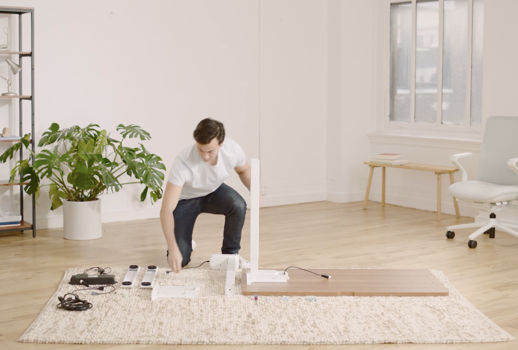 Person assembling furniture in a bright room