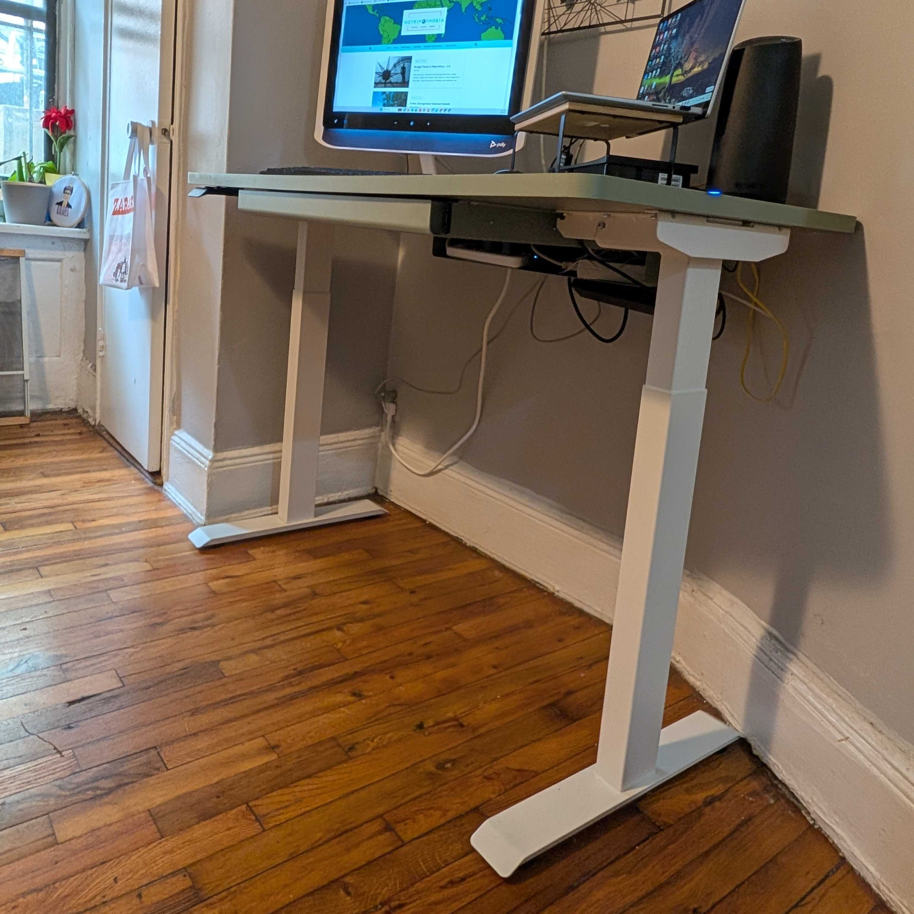 Home office with standing desk and computer setup