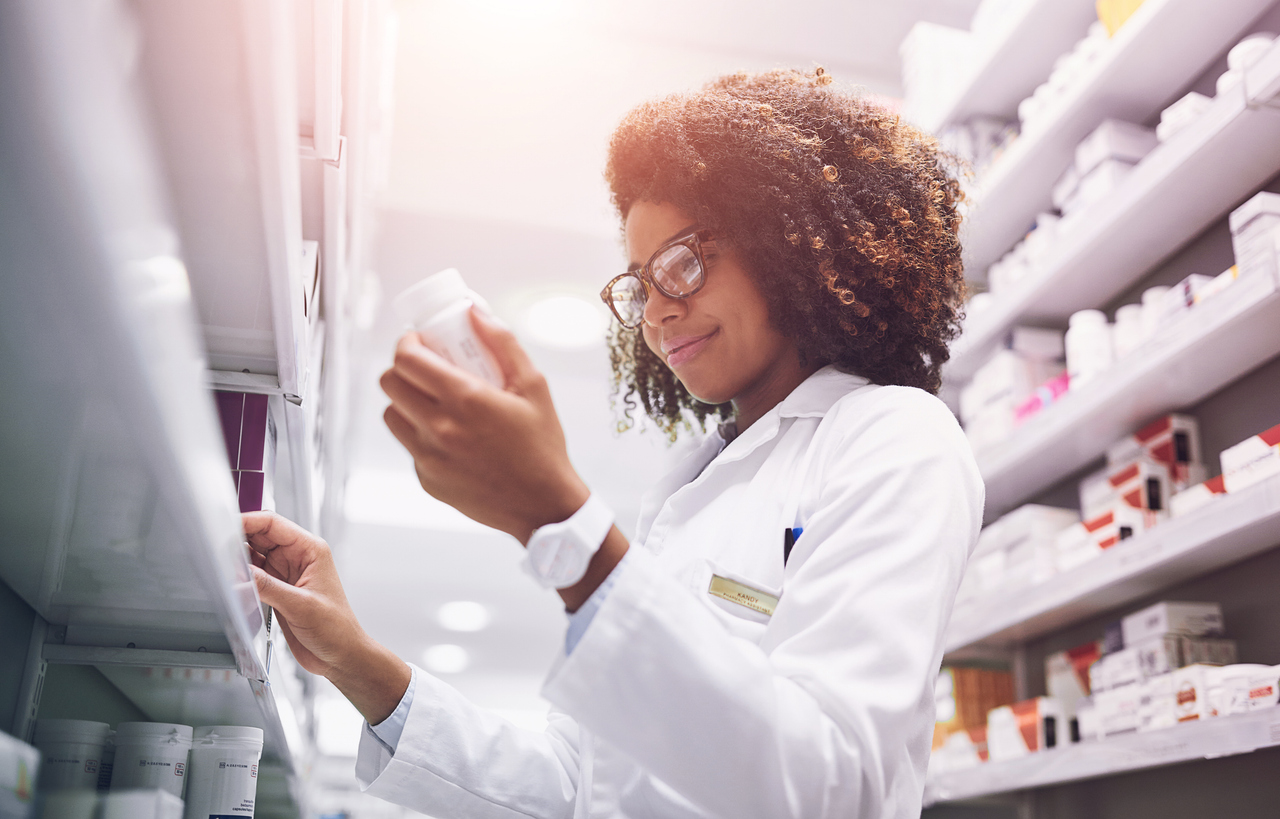 A pharmacist examining the label of a prescription bottle