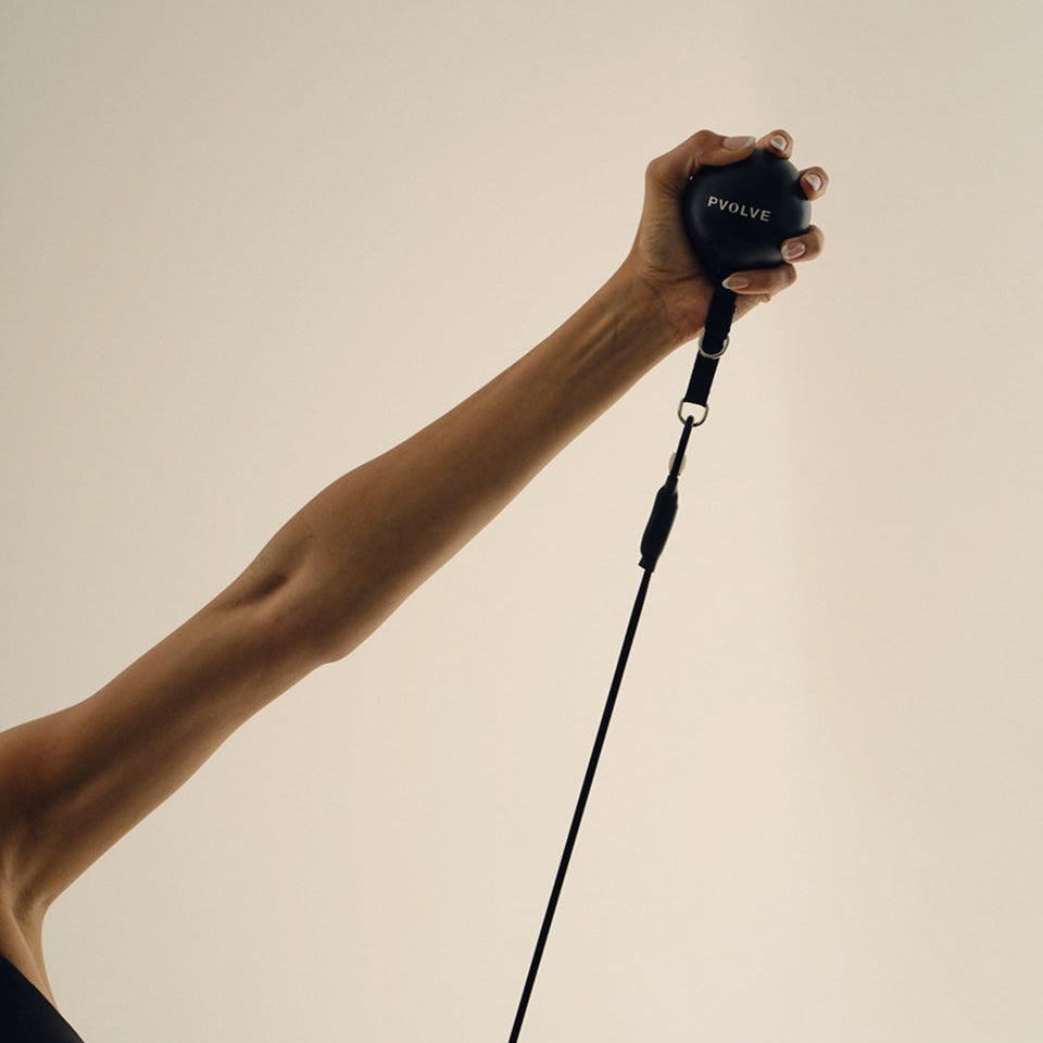 A woman working out with the P.3 Trainer