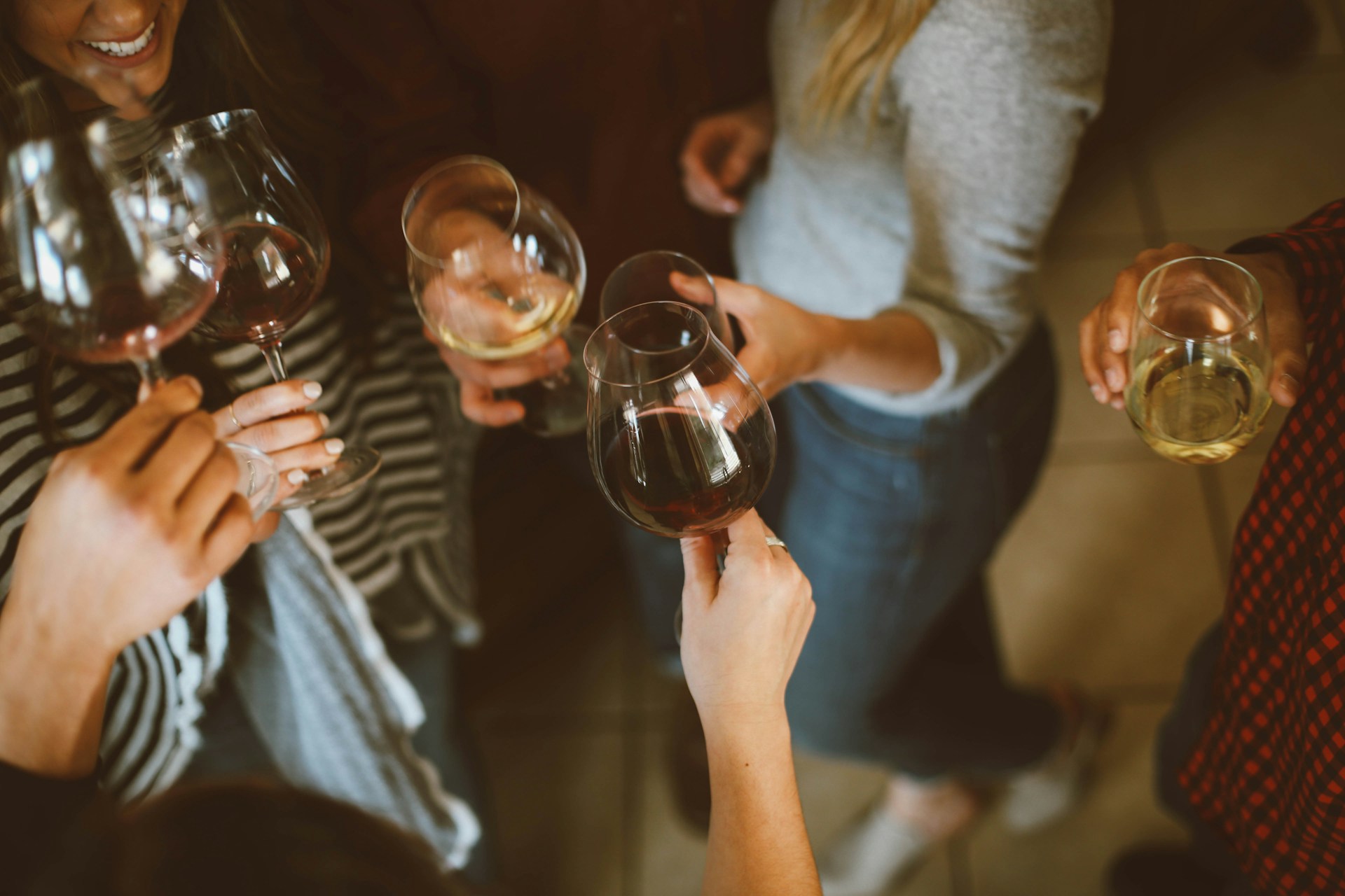 A small group of people holding wine glasses
