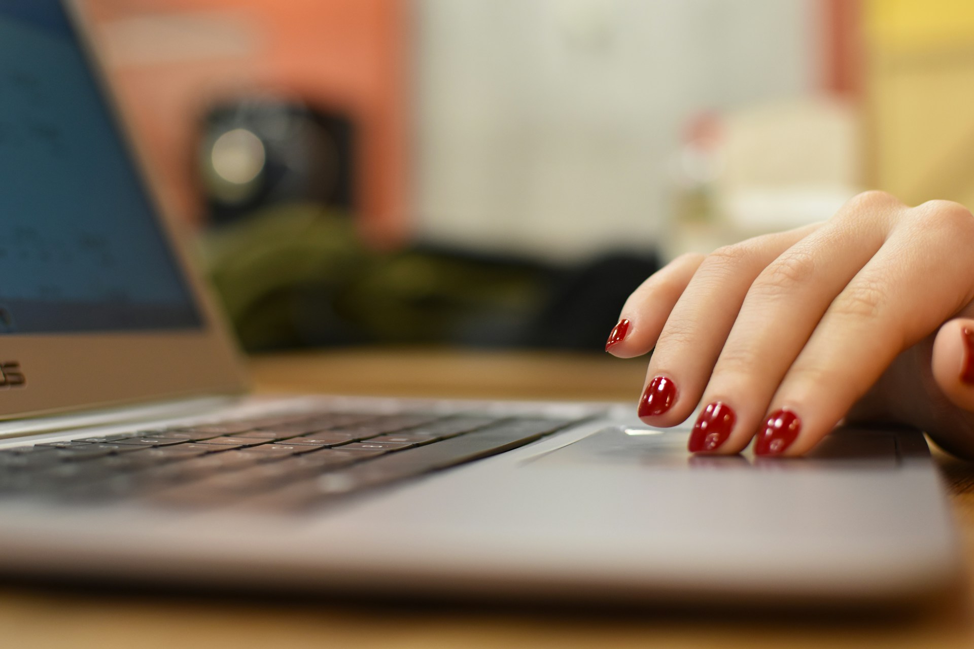 Woman's hand on the trackpad of a laptop