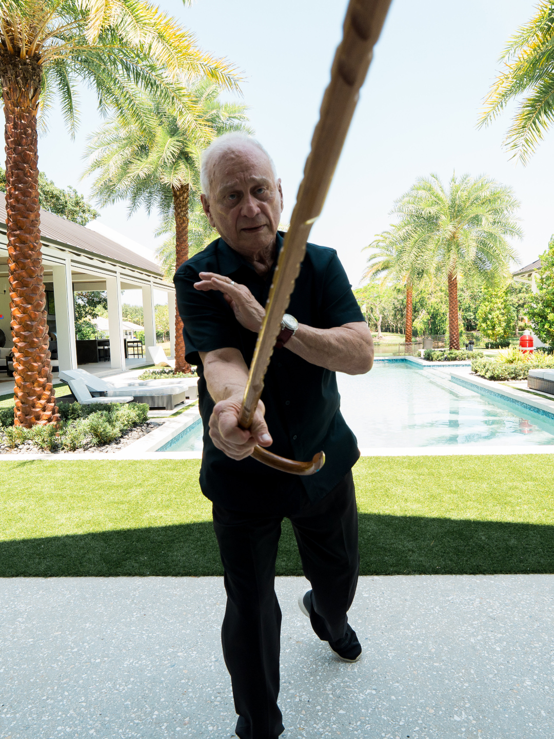 Man demonstrating cane self-defense technique outdoors