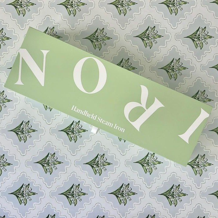 The Nori Press in its green box on a patterned background