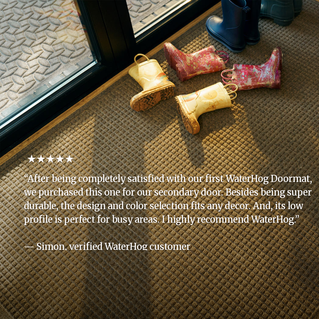 Rain boots on top of a WaterHog mat with a customer review overlaid