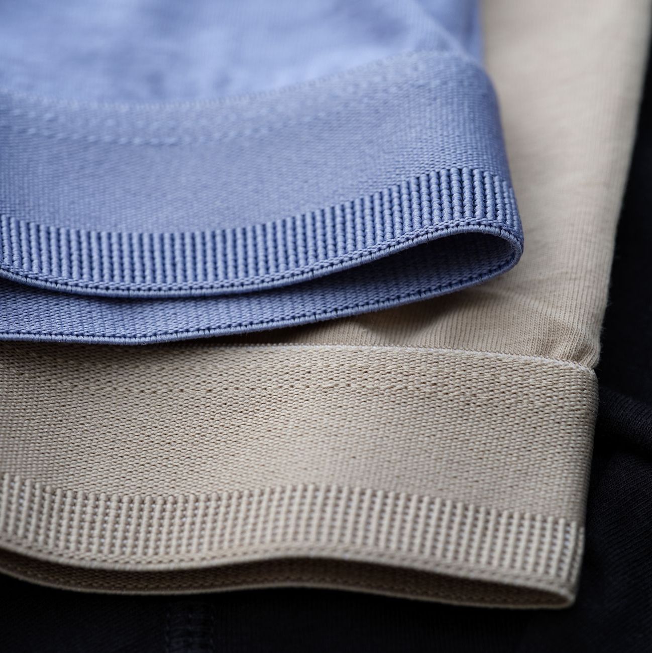 Close-up of men's underwear waistbands in various colors