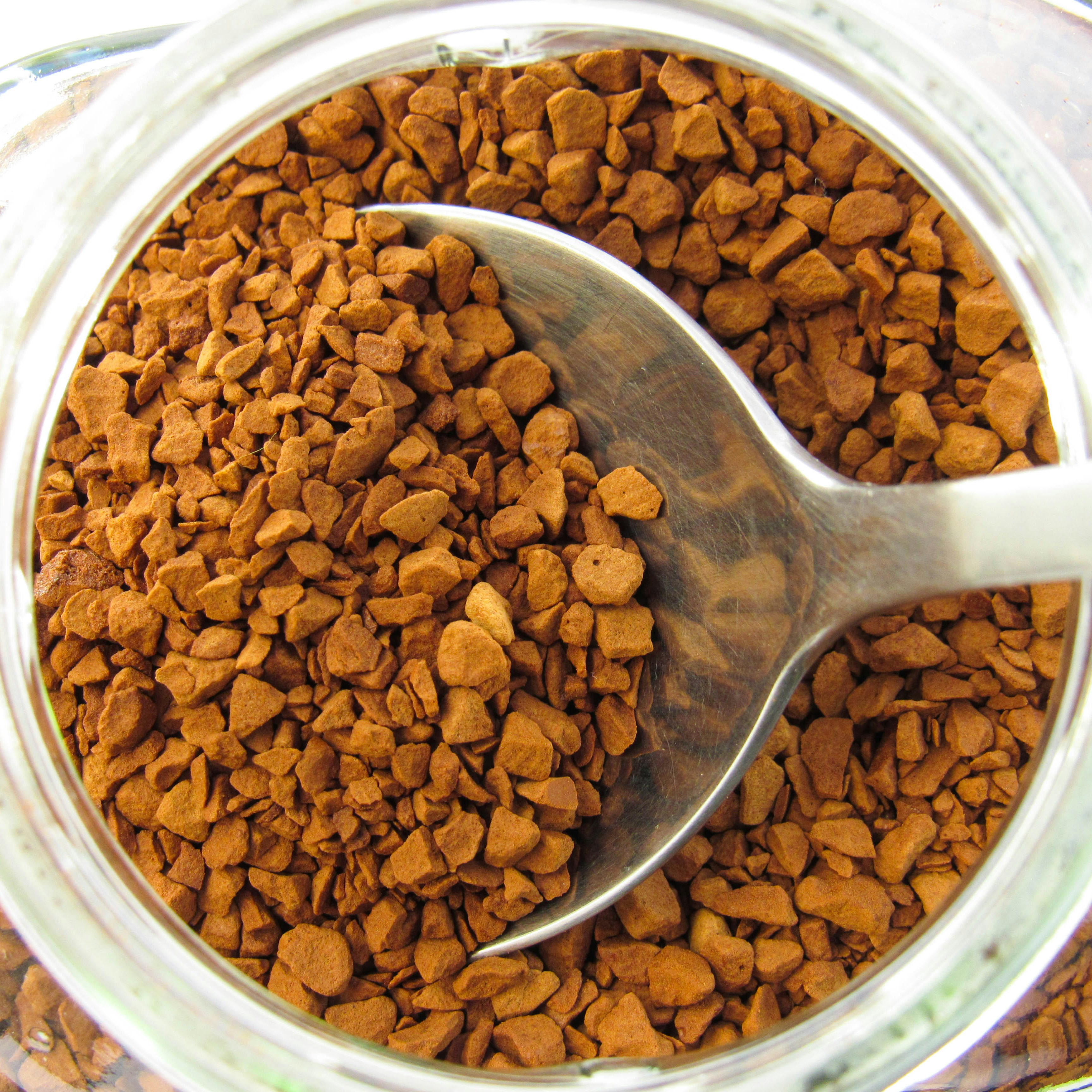Instant Coffee Granules in Jar A jar of instant coffee granules with a spoon inside, showcasing a pantry staple