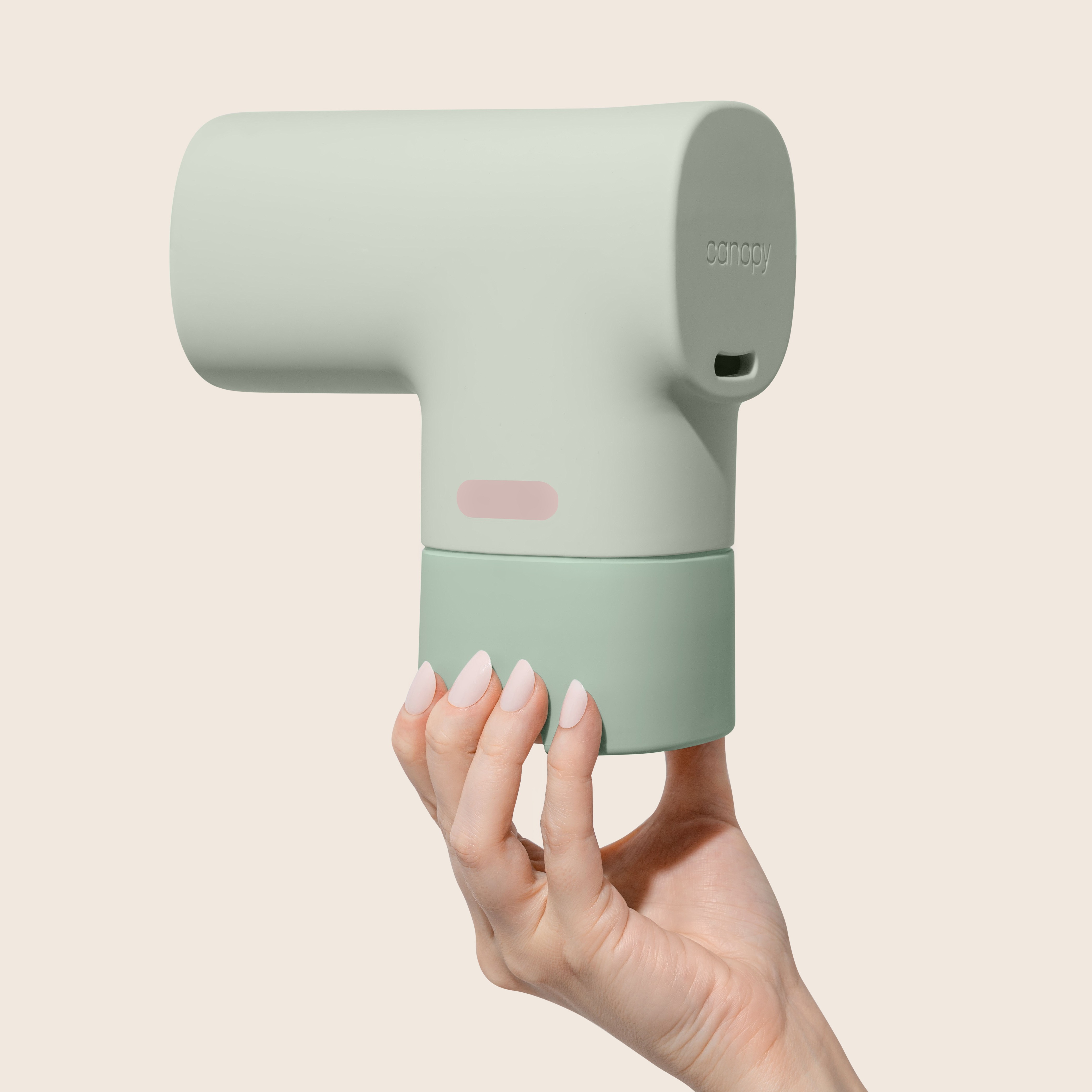 A hand holds a Canopy Baby Tub Bath Filter, showcasing its temperature indicator strip