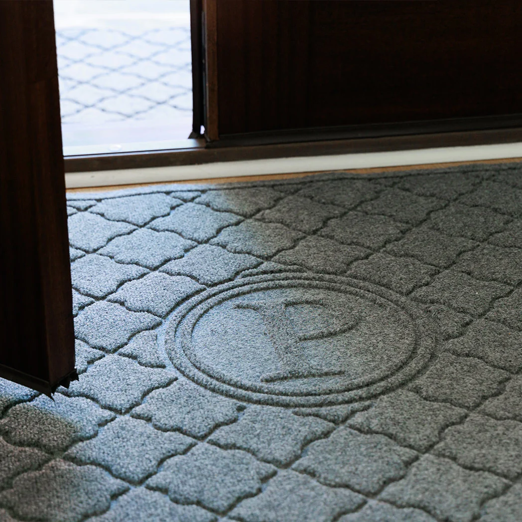 A monogrammed WaterHog doormat with the letter P enhances an entryway's decor
