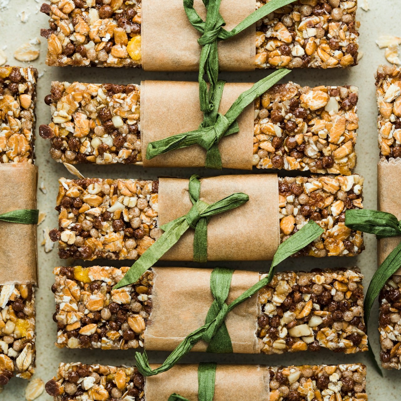Homemade Granola Bars Homemade granola bars wrapped in paper and tied with green string.