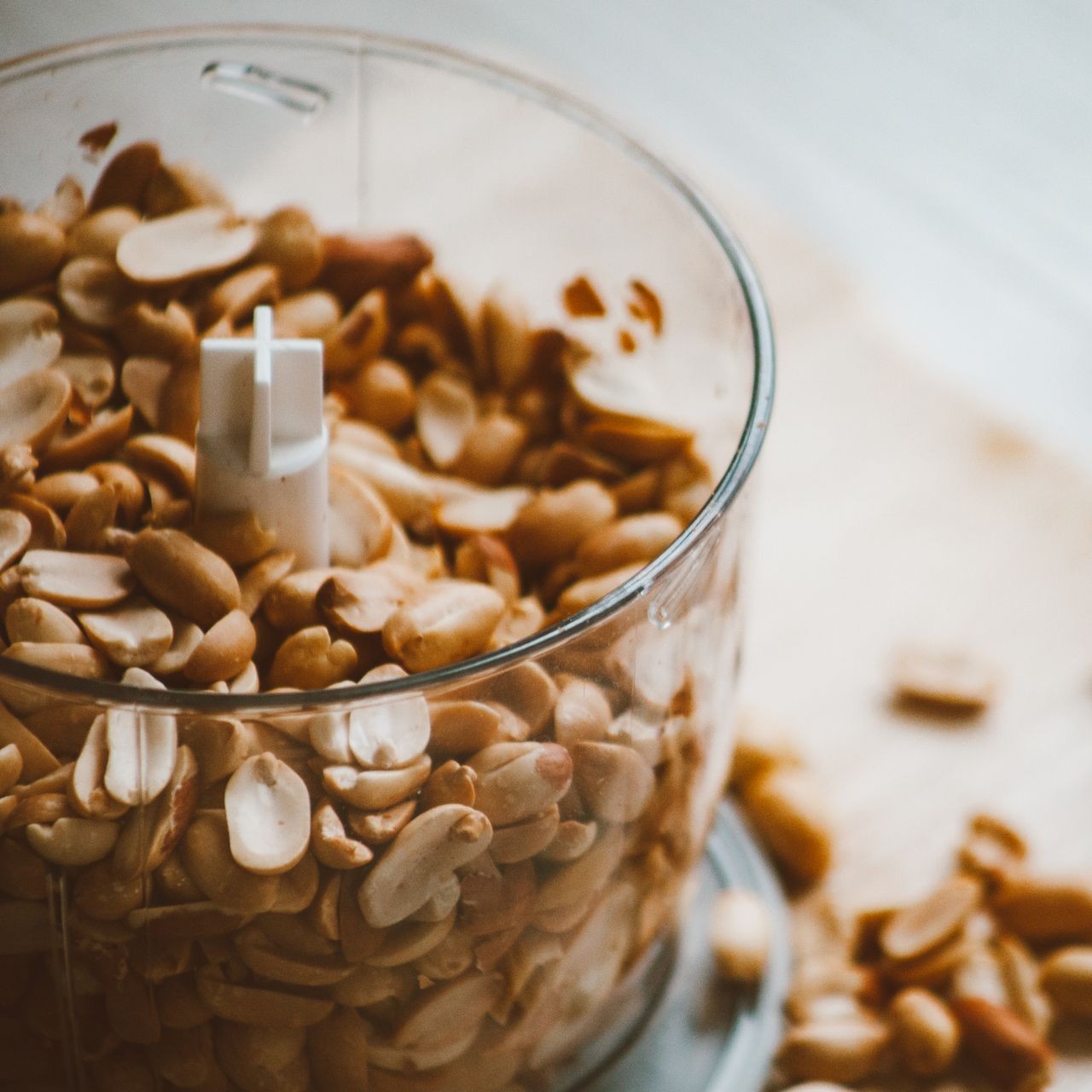 Peanuts in Food Processor A food processor filled with peanuts ready for grinding