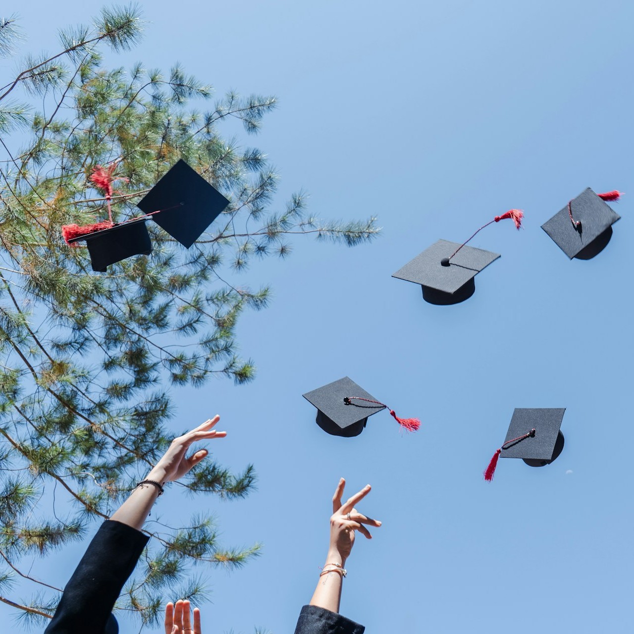 Students Celebrate Graduation Graduation caps are thrown into the air by students celebrating