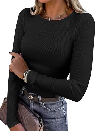 Person wearing a black long-sleeve top and holding a beige handbag.