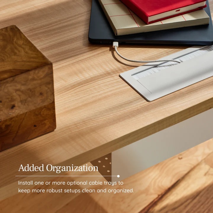 Organized Desk Surface with Cable Tray The optional cable tray is shown attached to the Tria L-Standing Desk