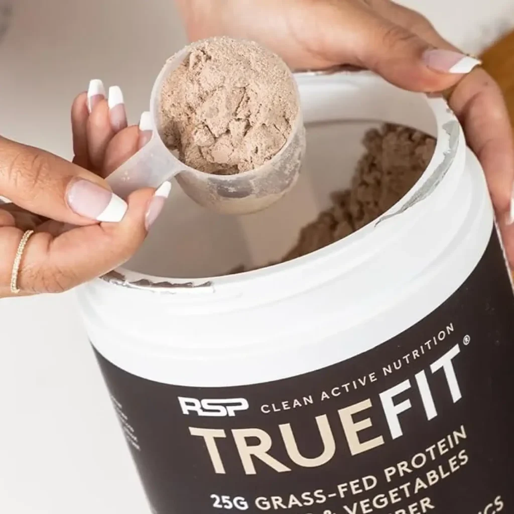 hand scooping truefit powder out of packaging hand scooping truefit powder out of packaging