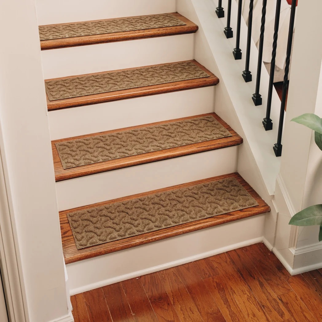Camel Dog Bone Stair Treads Camel-colored stair treads from WaterHog with a dog bone pattern cover wooden steps