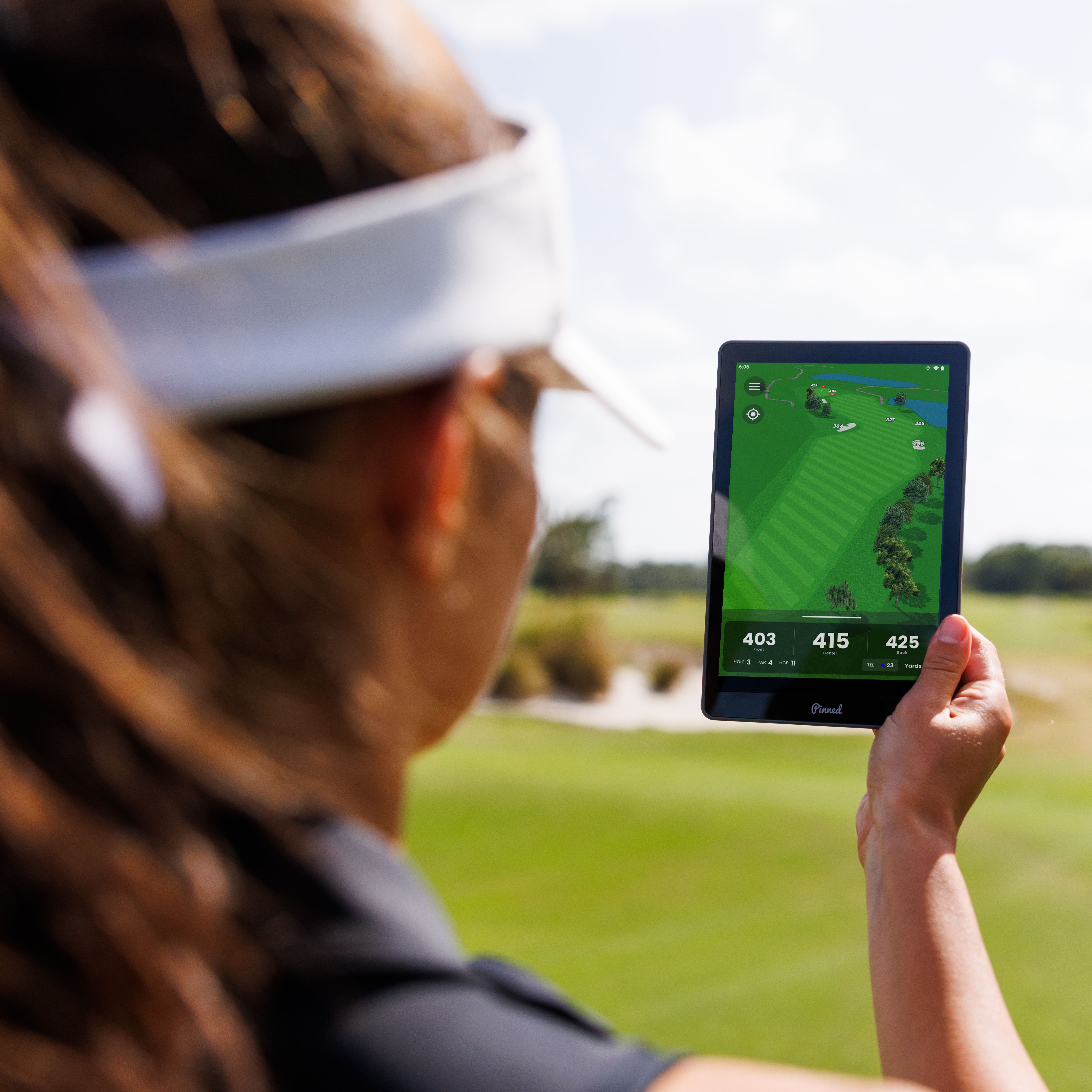 A golfer uses The Caddie to view a detailed map of a golf course hole