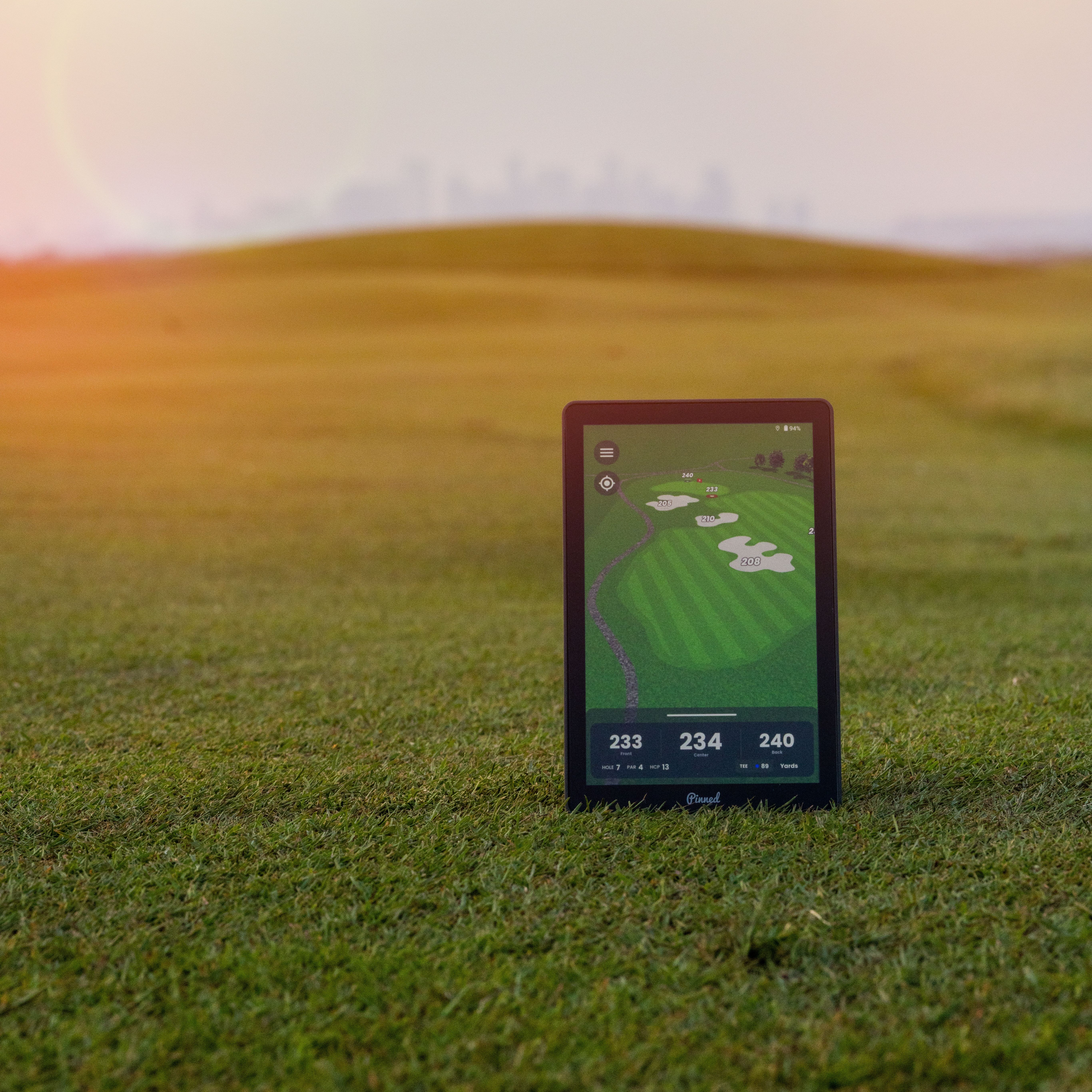 The Caddie displays a golf course layout on a fairway during sunset
