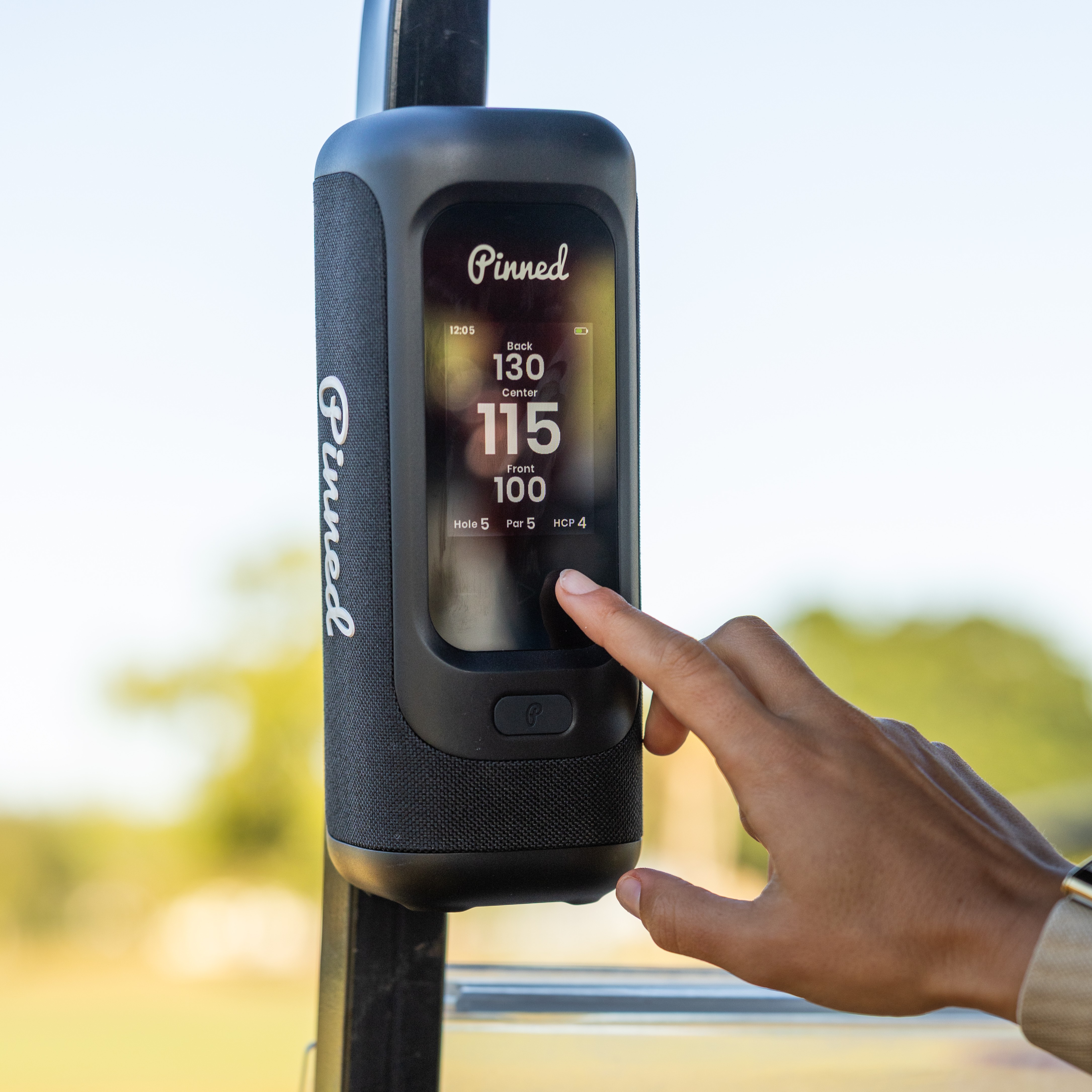 Sound Stick PRO Person reaches for the touchscreen of the Sound Stick PRO, which is displaying golf course data